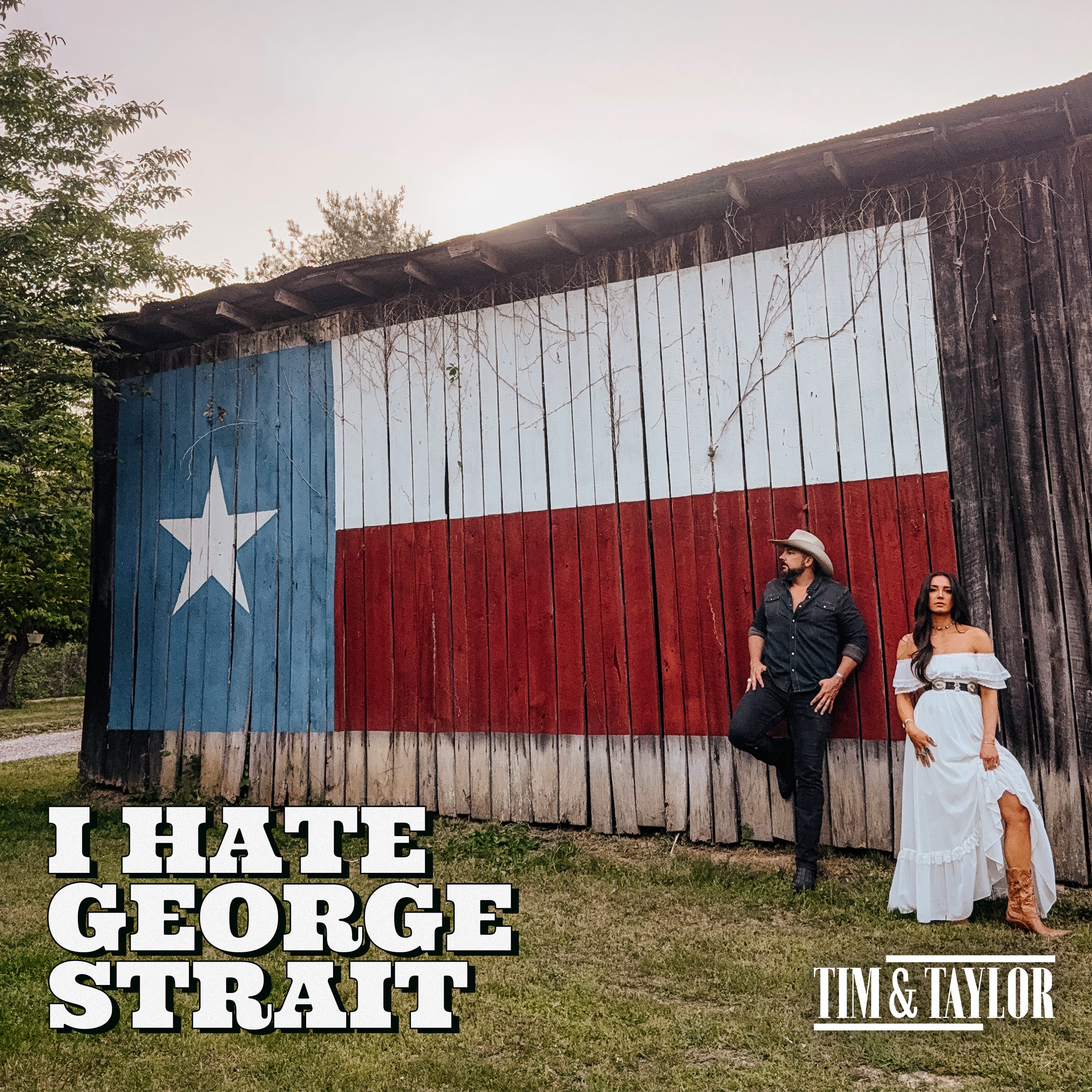 Tim & Taylor I Hate George Strait single cover art, the duo by a barn painted with the Texas flag